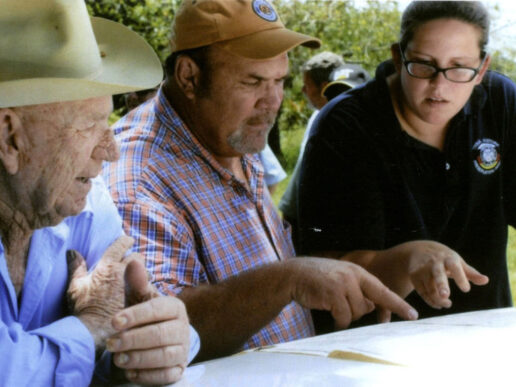 Tribal Archaeologist Maureen Mahoney (far right) speaks with the late Neal Brown (far left), grandson of Bill Brown who built an early 20th century trading post on what is now the Big Cypress Reservation — Tribal Archaeology — Seminole Tribal Historic Preservation Office